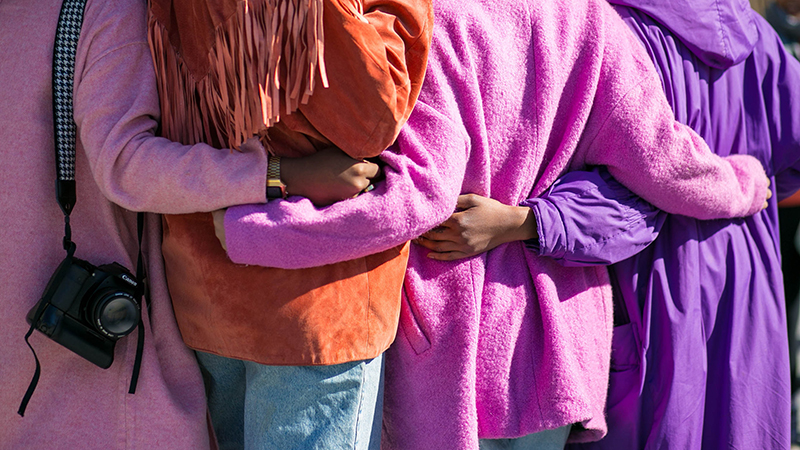 women dressed in colourful coats